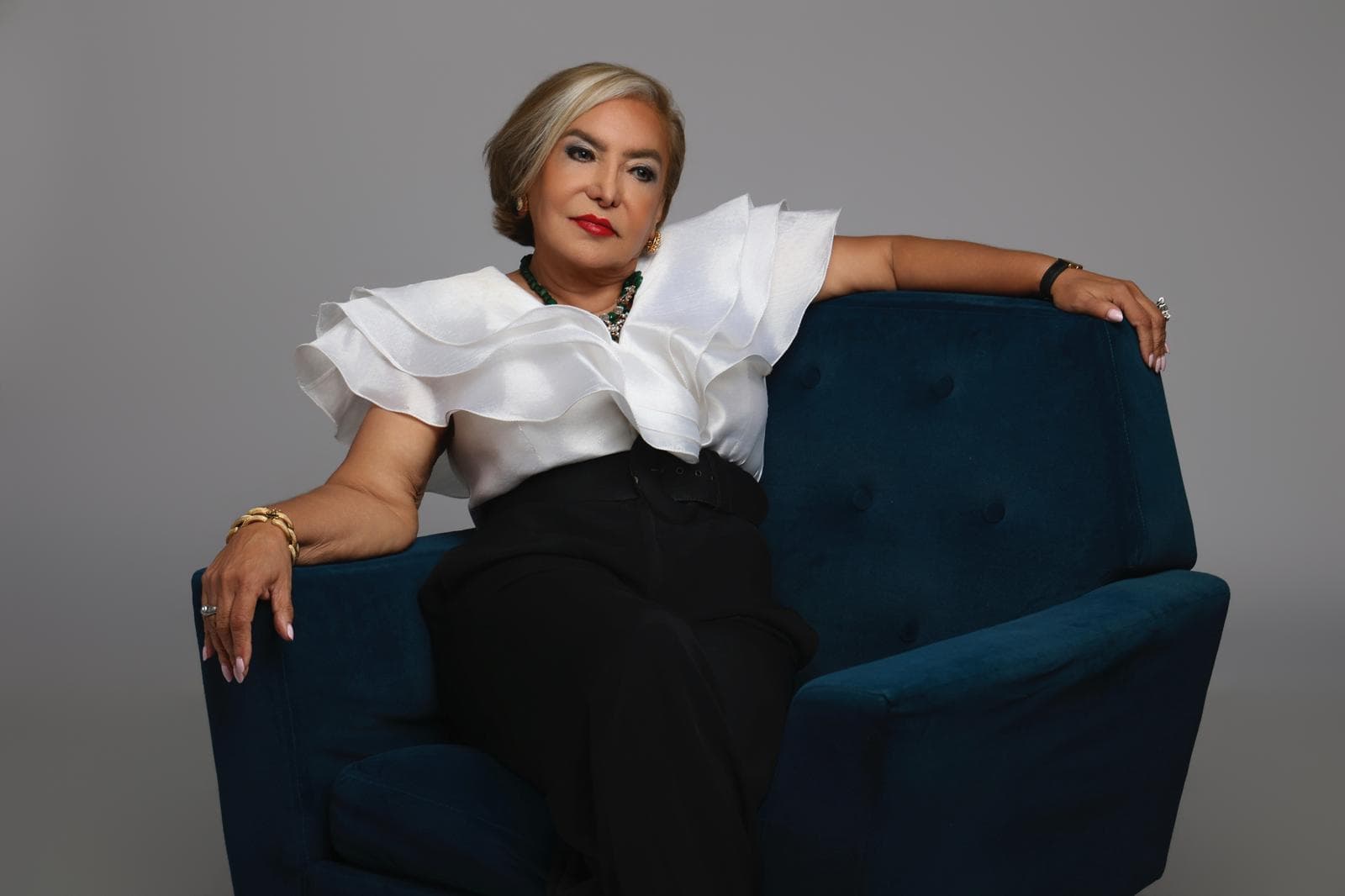 Veronica Medellin seated in luxury studio portrait